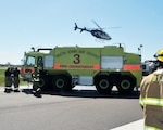 A helicopter from Wings Air Rescue arrives at Sioux Gateway Airport Col. Bud Day Field to pick up a load of simulated casualties to deliver to a hospital during a Federal Aviation Administration mass casualty exercise at the airport in Sioux City, Iowa, May 1, 2021. The Iowa Air National Guard's 185th Air Refueling Wing participated in the exercise.