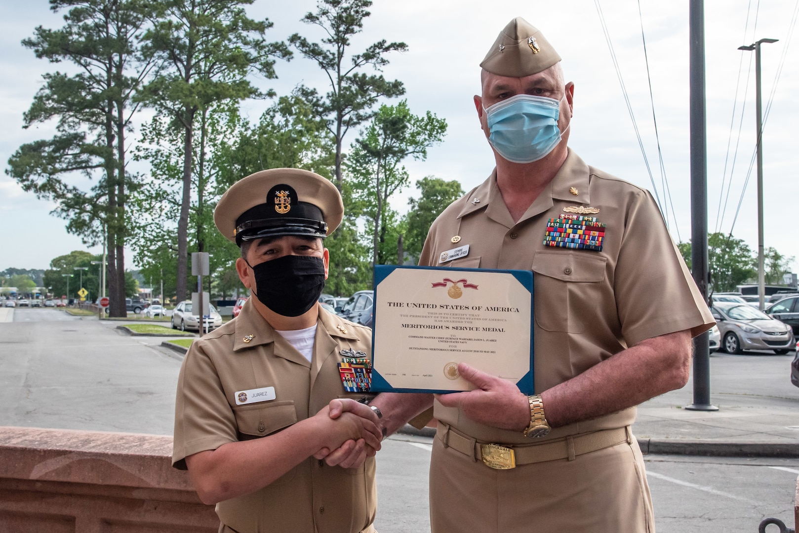 Capt Stephens presenting MSM to Command Master Chief Juarez