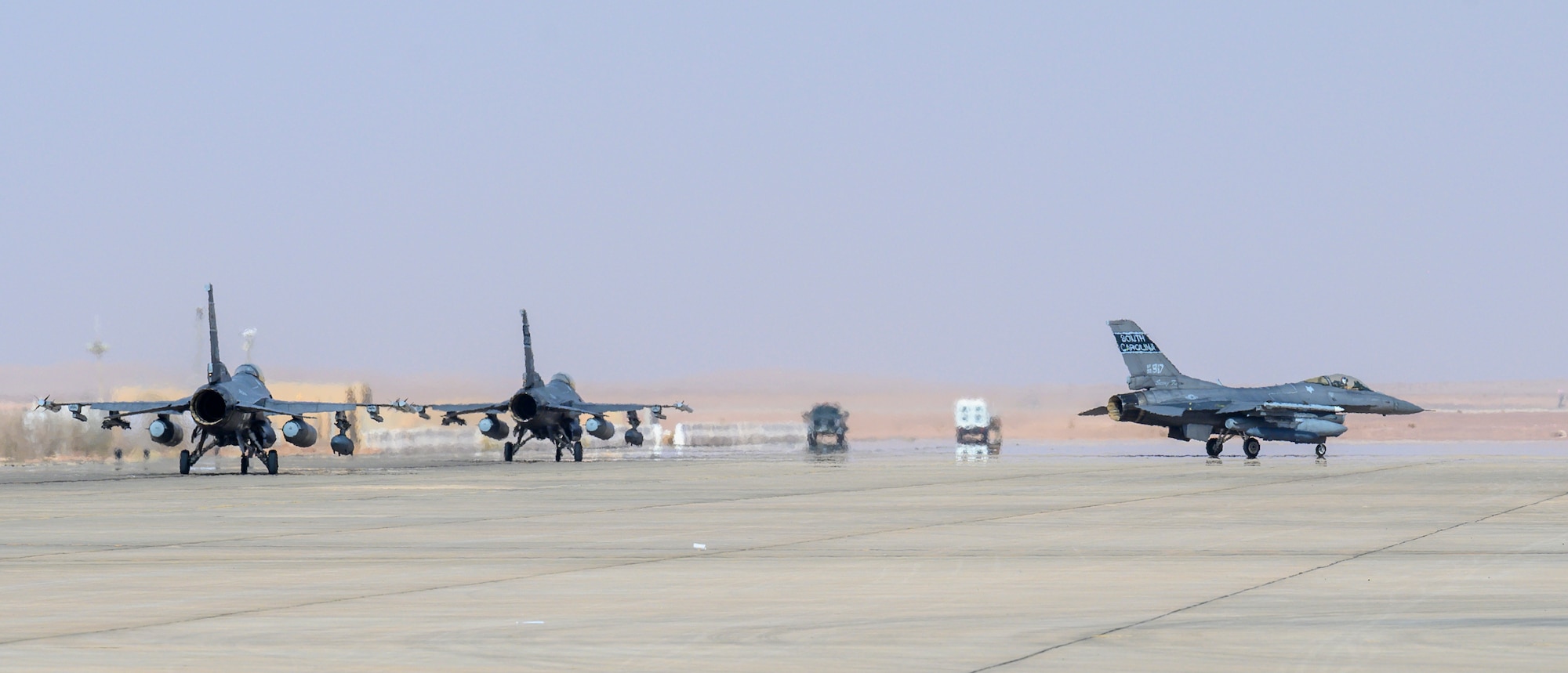 A contingent of U.S. Air Force F-16CJ Fighting Falcons from South Carolina Air National Guard’s 169th “Swamp Fox” Fighter Wing taxi on the flight line upon arrival at Prince Sultan Air Base, Kingdom of Saudi Arabia, April 14, 2021. The Swamp Fox team has been deployed to PSAB to help bolster the defensive capabilities against potential threats in the region. (U.S. Air Force Photo by Senior Airman Samuel Earick)