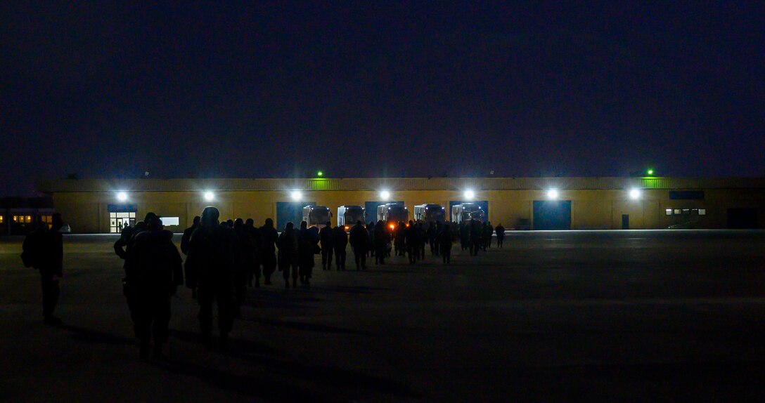 Airmen from South Carolina Air National Guard’s 169th “Swamp Fox” Fighter Wing load into buses to in-process at Prince Sultan Air Base, Kingdom of Saudi Arabia, April 12, 2021. The Swamp Fox team has been deployed to PSAB to help bolster the defensive capabilities against potential threats in the region. (U.S. Air Force Photo by Senior Airman Samuel Earick)
