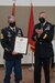 Soldiers pose with certificate