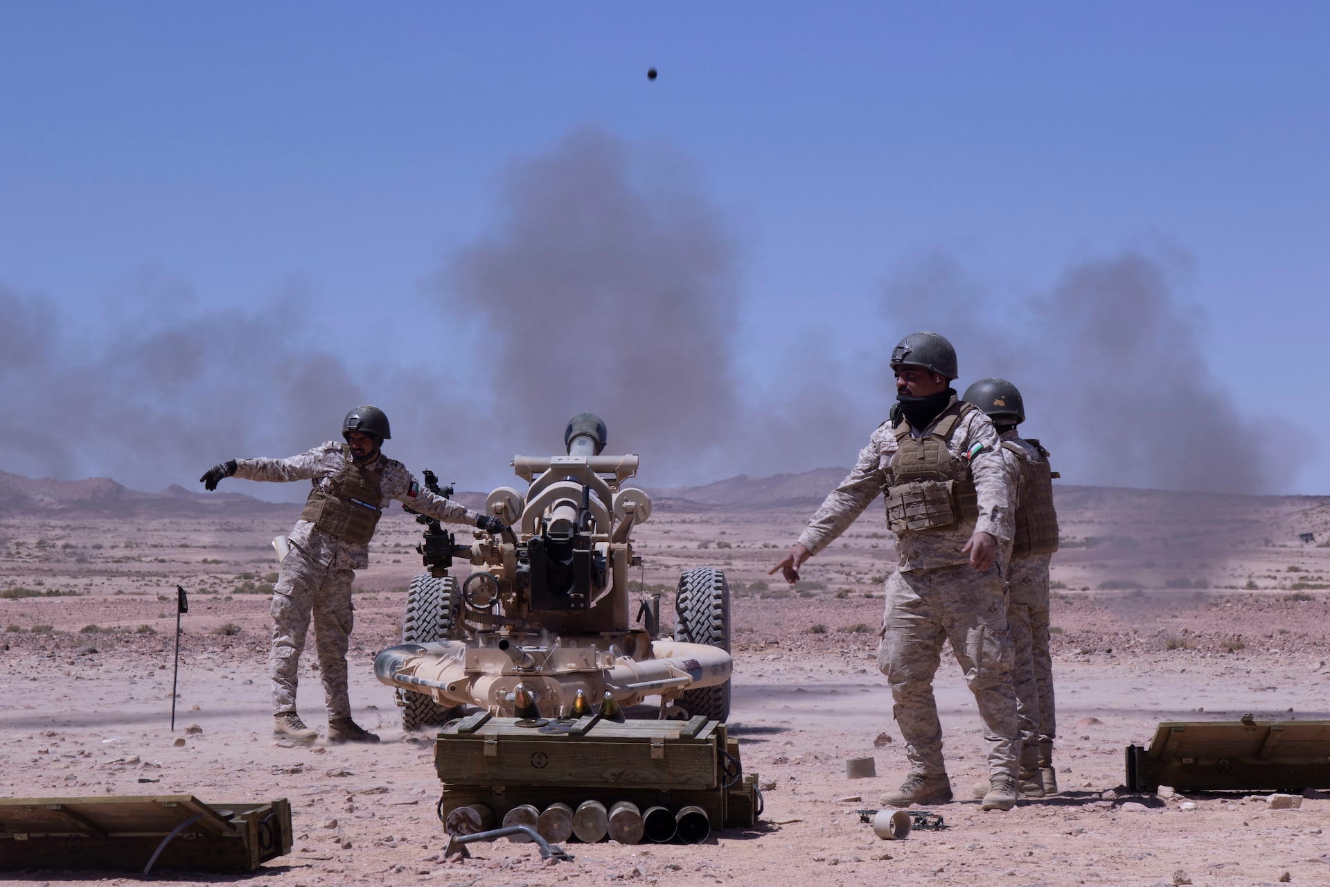 QRF Brigade field artillery gun crew fire the M119A2 105mm Howitzer at the Al Quwayrah Training Area, Jordan. The artillery gun crew, a mortar crew, and Jordanian Royal Marines participated in live fire exercise over the course of a week.