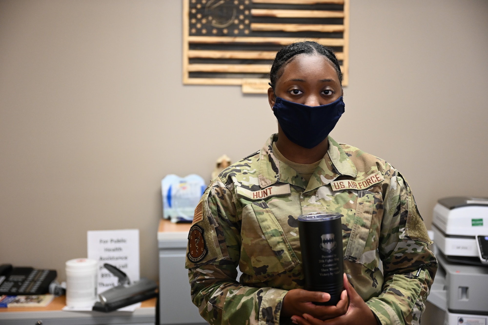 Airman 1st Class Shadrica Hunt poses with weasel mug.