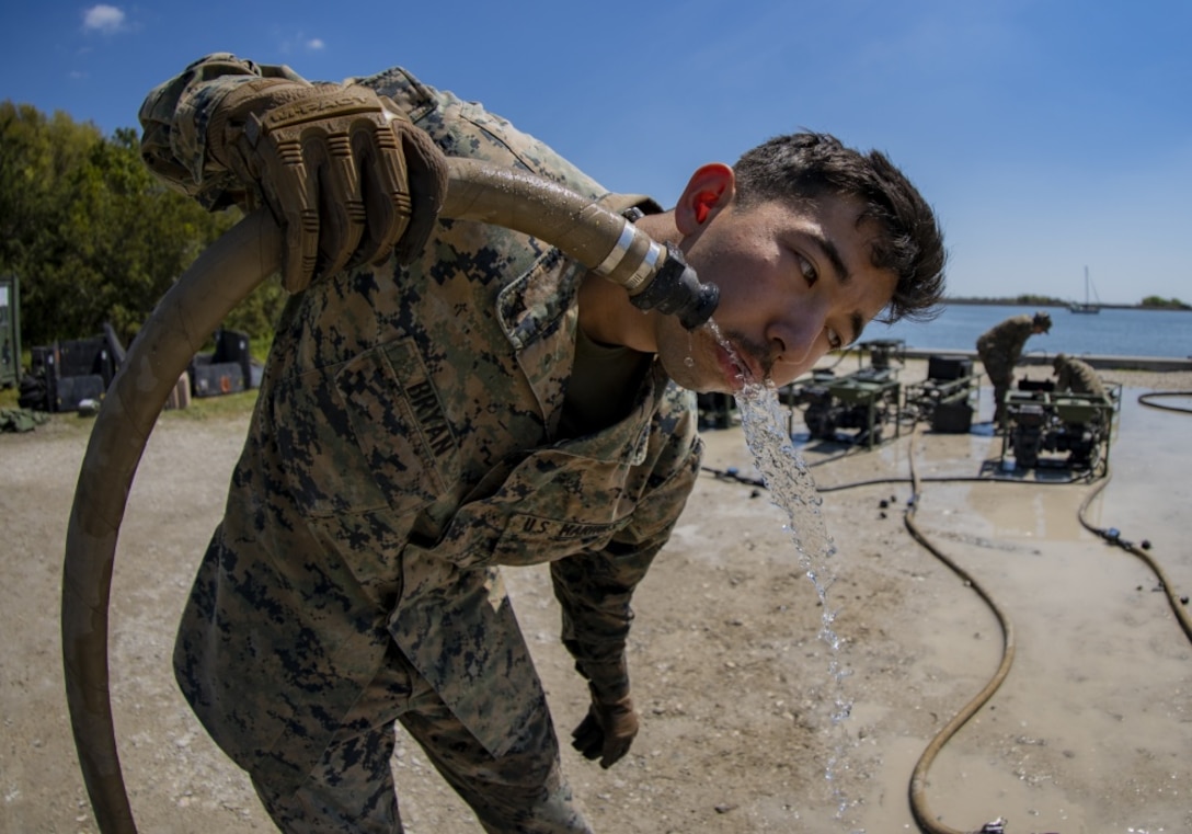 Lance Cpl. Anthony Bryan, a water support technician with Special Purpose Marine Air-Ground Task Force - Southern Command, reviews recently purified water’s chlorine level during the command post exercise at Camp Lejeune, N.C., April 8, 2020. Water support technician Marines used lightweight water purification systems to purify water before providing it to the combat engineer Marines working at another site. The CPX increases readiness and challenges SPMAGTF-SC command and control, communications and timely decision-making capabilities through simulated real-world scenarios. SPMAGTF-SC will be deployed into the Southern Command area of operation to provide crisis response preparedness efforts, security cooperation training and engineering events to help strengthen relations with partner nations throughout Central and South America. Bryan is a native of Eugene, Oregon.