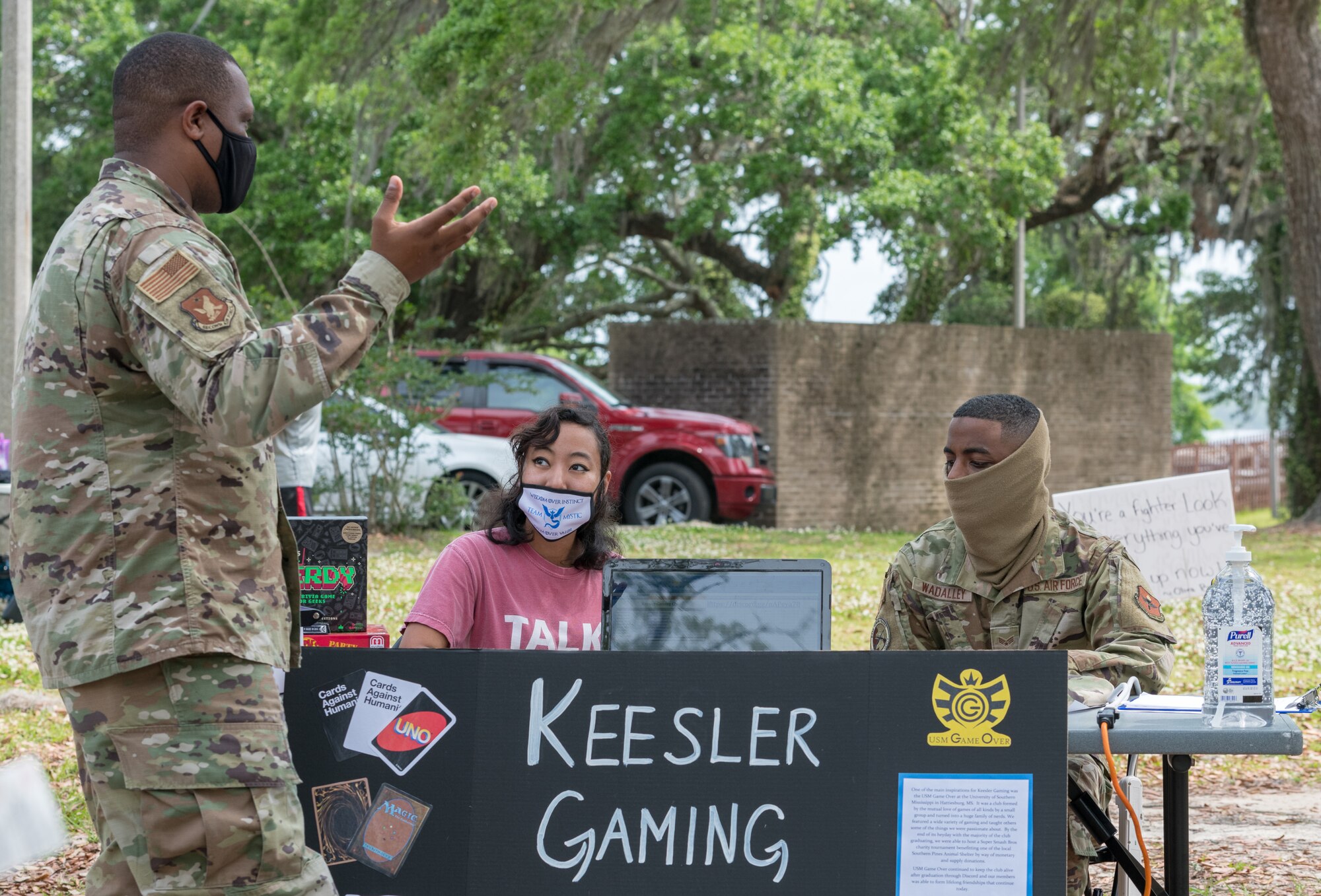 U.S. Air Force 1st Lt. Alvin Cantey, 2nd Air Force innovation and analytics officer in charge, receives information from the Gaming Club during the Keesler Club Day event at the Marina Park at Keesler Air Force Base, Mississippi, April 29, 2021. The event consisted of a variety of clubs offering information about the benefits they have to offer Keesler personnel and their families. (U.S. Air Force photo by Andre' Askew)