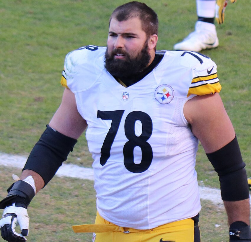 A football player walks on the football field.