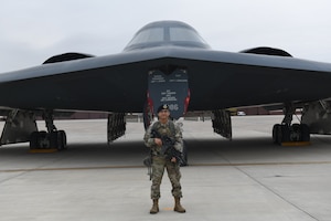 Airman 1st Class Elijah R. Posana, security response team member with the 509th Security Forces Squadron, stands in front of B-2 Spirit at Whiteman Air Force Base, Missouri, Nov. 18, 2020. Members of the 509th SFS protect both personnel and assets supporting the U.S. Air Force Global Strike's stealth bomber fleet. (U.S. Air Force photo by Staff Sgt. Alexandria Lee)