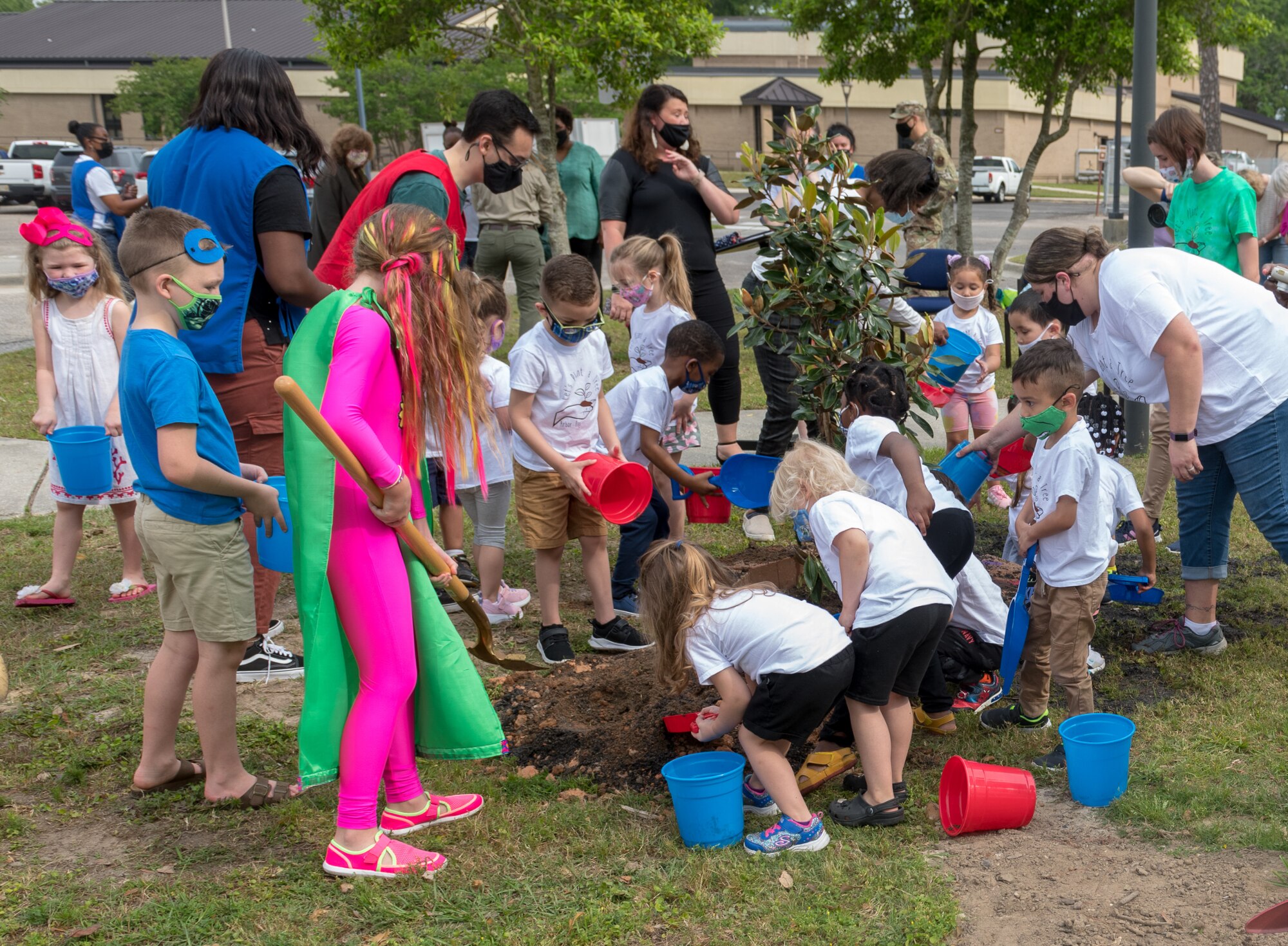 A preschool class at the child development center plants a tree in honor of Arbor Day during the Arbor Day Celebration at Keesler Air Force Base, Mississippi, April 30, 2021. A proclamation was also read during the event. (U.S. Air Force photo by Andre' Askew)