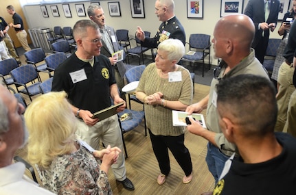 An officer candidates in class 58 of the Virginia Army National Guard Officer Candidate School speaks with the family of Capt. Harry Q. Rose at a ceremony commemorating the 58th birthday of the Virginia OCS April 19, 2016, at J. Sargeant Reynolds Community College’s Downtown Campus in Richmond, Virginia. Rose, a graduate of Class VIII, was killed in Vietnam in 1969 and remains the only Virginia OCS graduate to have been killed in action. (Photo by Master Sgt. A.J. Coyne, Virginia Guard Public Affairs)