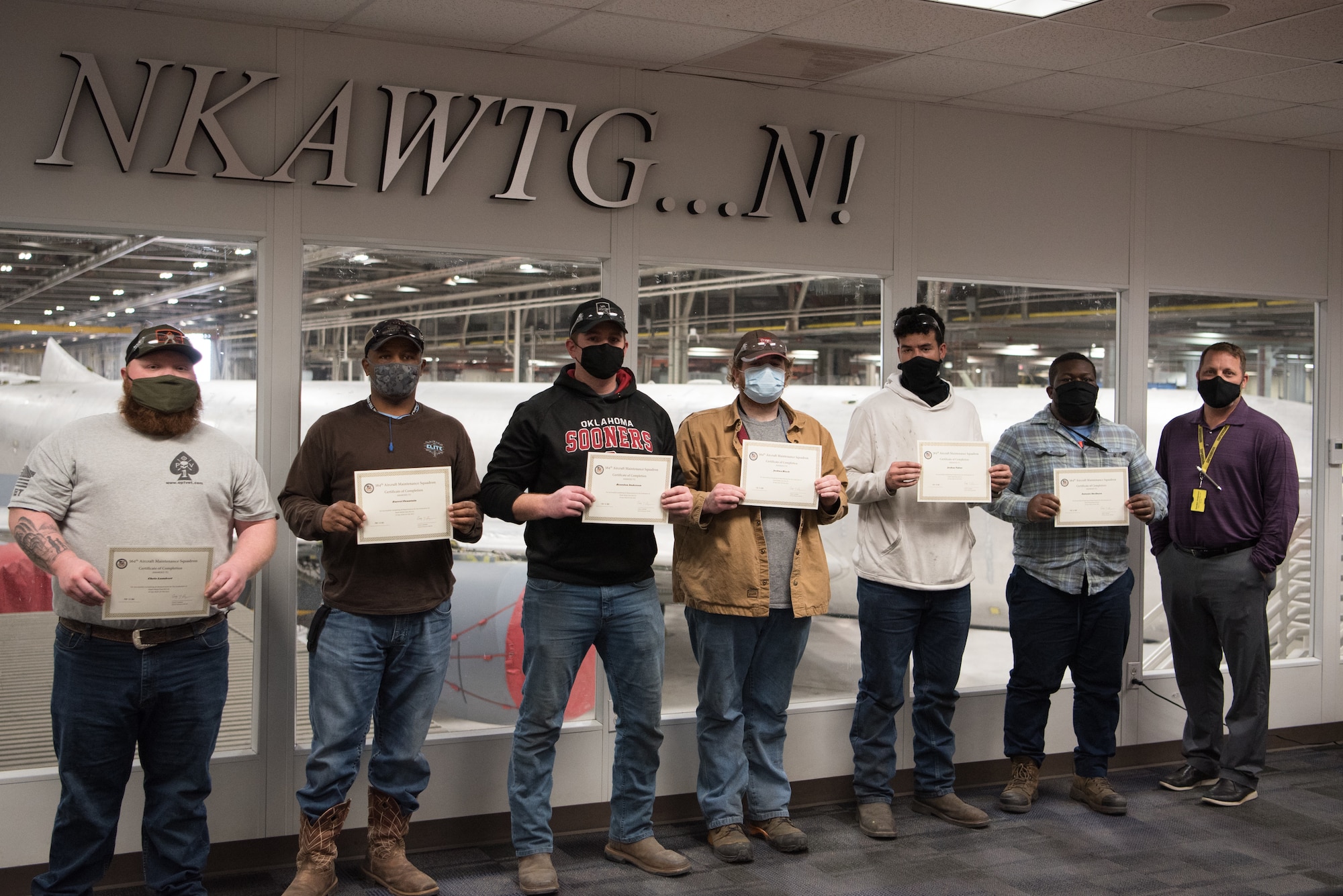 Graduates of the sheet metal vocational program pose for a group photo.