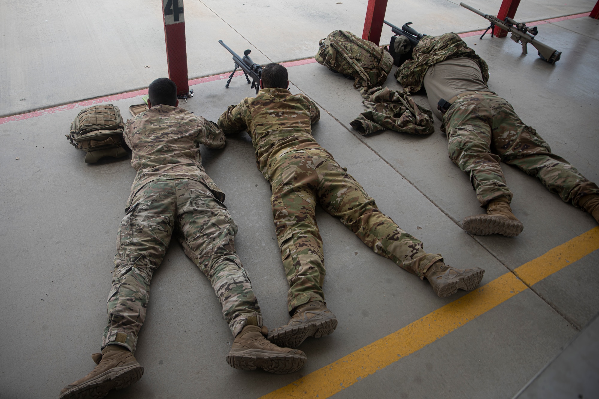 A photo of an Airman aiming a weapon