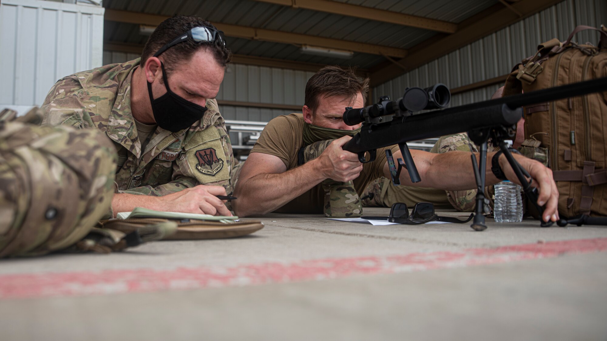 A photo of an Airman aiming a weapon