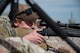 A photo of an Airman aiming a weapon