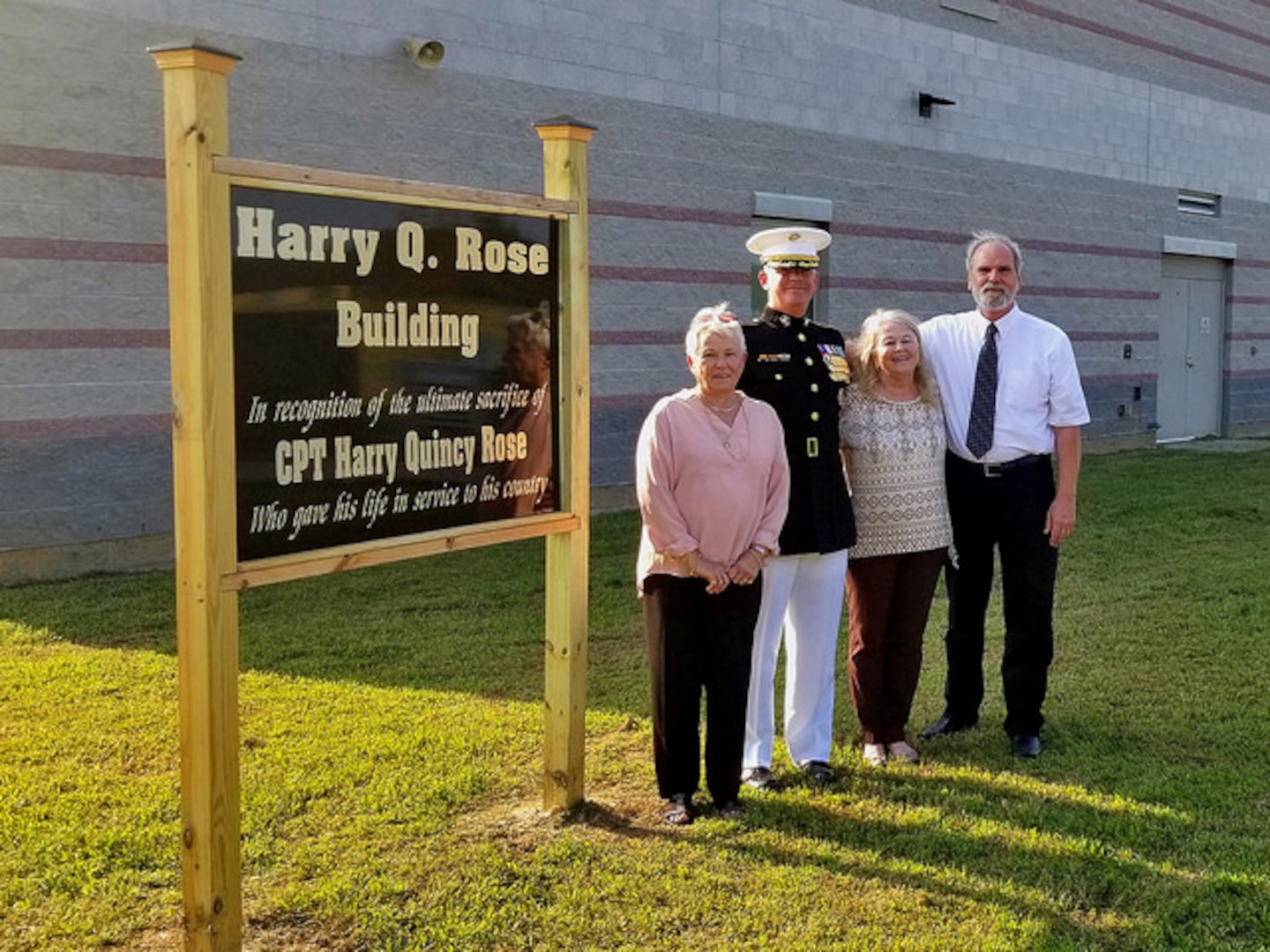 (L-R) Helen Rose Creel, Lt. Col. Harry Gardner, Phyllis Rose Gardner and Albert Lee Creel stand next to the sign commemorating Capt. Harry Q. Rose, Sept. 22, 2018, at the Virginia National Guard’s Officer Candidate School building at Fort Pickett, Virginia. (U.S. Army National Guard Photo by Staff Sgt. Matt Lyman)