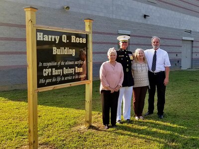 (L-R) Helen Rose Creel, Lt. Col. Harry Gardner, Phyllis Rose Gardner and Albert Lee Creel stand next to the sign commemorating Capt. Harry Q. Rose, Sept. 22, 2018, at the Virginia National Guard’s Officer Candidate School building at Fort Pickett, Virginia. (U.S. Army National Guard Photo by Staff Sgt. Matt Lyman)