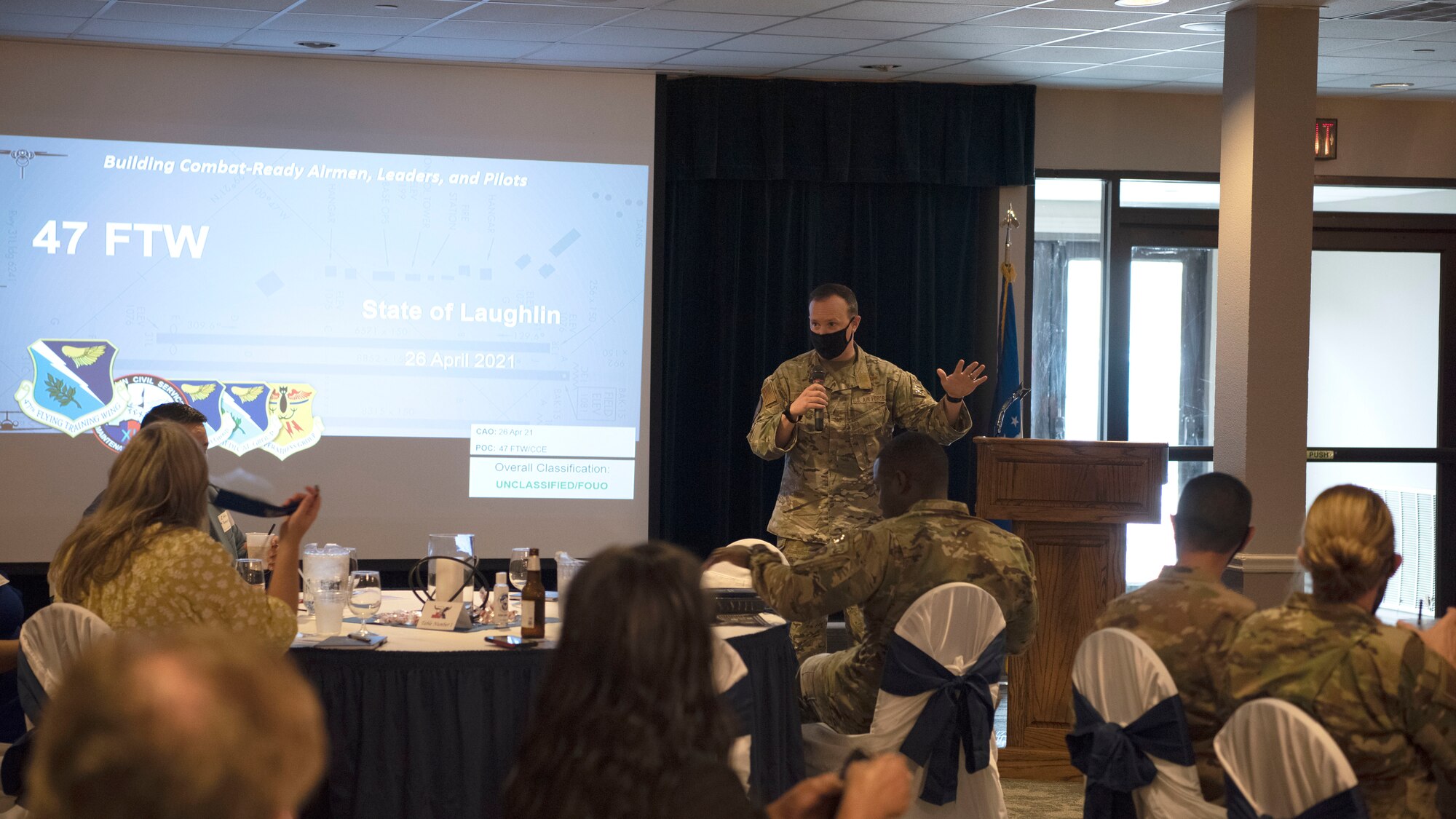 Col. Craig Prather, 47th Flying Training Wing commander and Attendees from the local area converse on April 26th, 2021 at Laughlin Air Force Base, Texas. Col Prather begins his adress with a few words to help the local community members settle in before his adress at the first annual State of Laughlin. (U.S. Air Force photo by Senior Airman Nicholas Larsen)