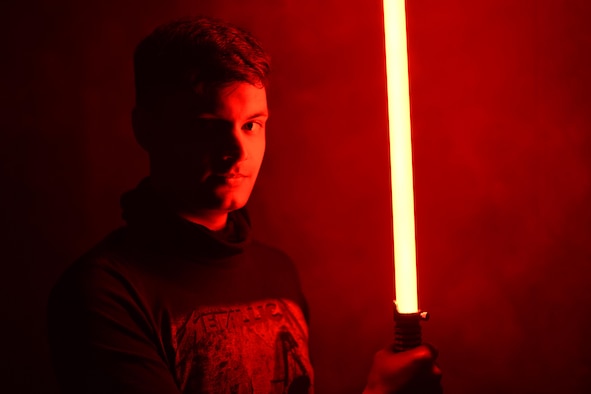 person holds lightsaber