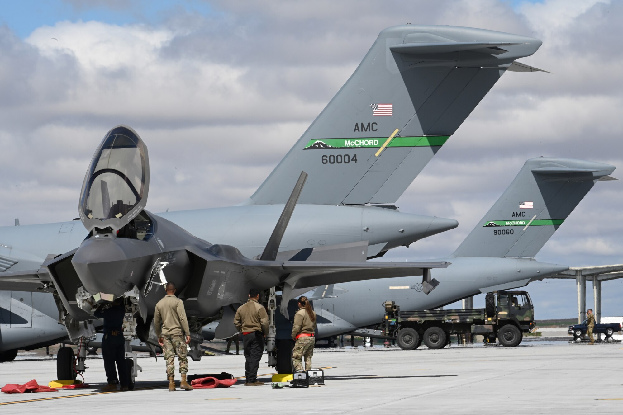 Airmen from Hill Air Force Base, Utah, observe an F-35 Lightning II April 26, 2021, on the flight line at Mountain Home AFB, Idaho. Airmen across the western United States participated in exercise Rainier War, testing their abilities to employ air combat capabilities during a time of potentially imminent foreign aggression. (U.S. Air Force photo by Staff Sgt. Christian Conrad)