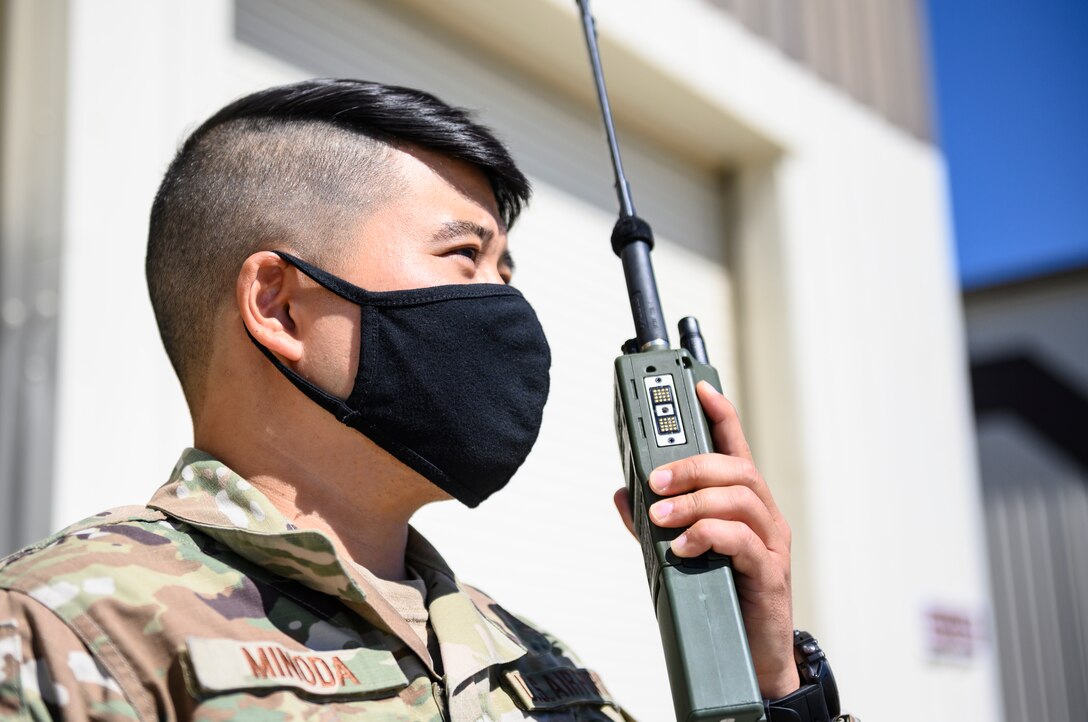 Tech. Sgt. Joshua Minoda, 821st Contingency Response Squadron maintenance flight chief, communicates with accessory units via radio April 27, 2021, at Mountain Home Air Force Base, Idaho. Minoda participated in exercise Rainier War, testing his ability to employ air combat capabilities during a time of potentially imminent foreign aggression. (U.S. Air Force photo by Staff Sgt. Christian Conrad)