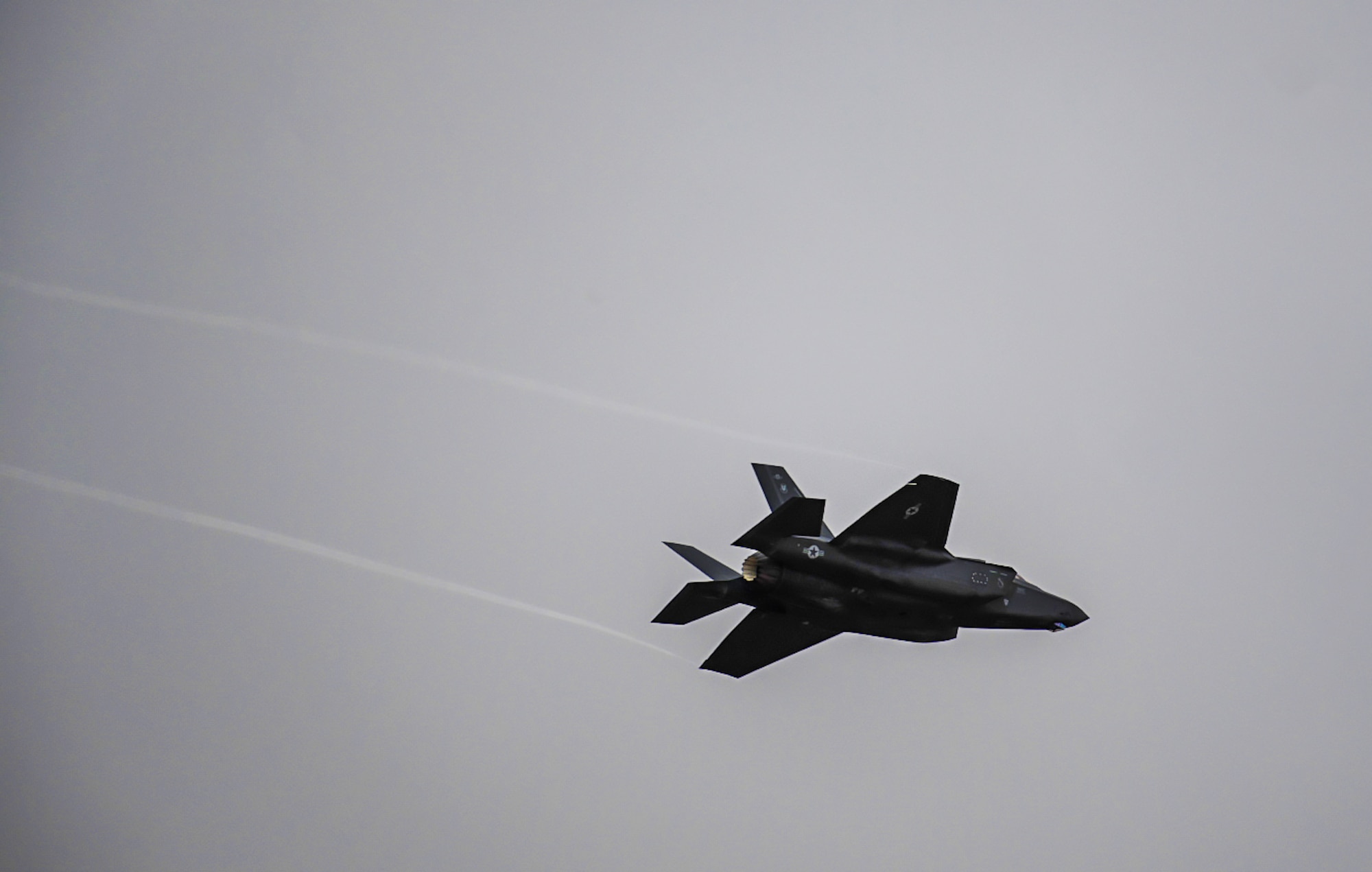 An F-35 Lightning II from Hill Air Force Base, Utah, flies over the flight line at Mountain Home AFB, Idaho, April 28, 2021. The F-35 participated in exercise Rainier War, testing its abilities to employ air combat capabilities during a time of potentially imminent foreign aggression. (U.S. Air Force photo by Staff Sgt. Christian Conrad)