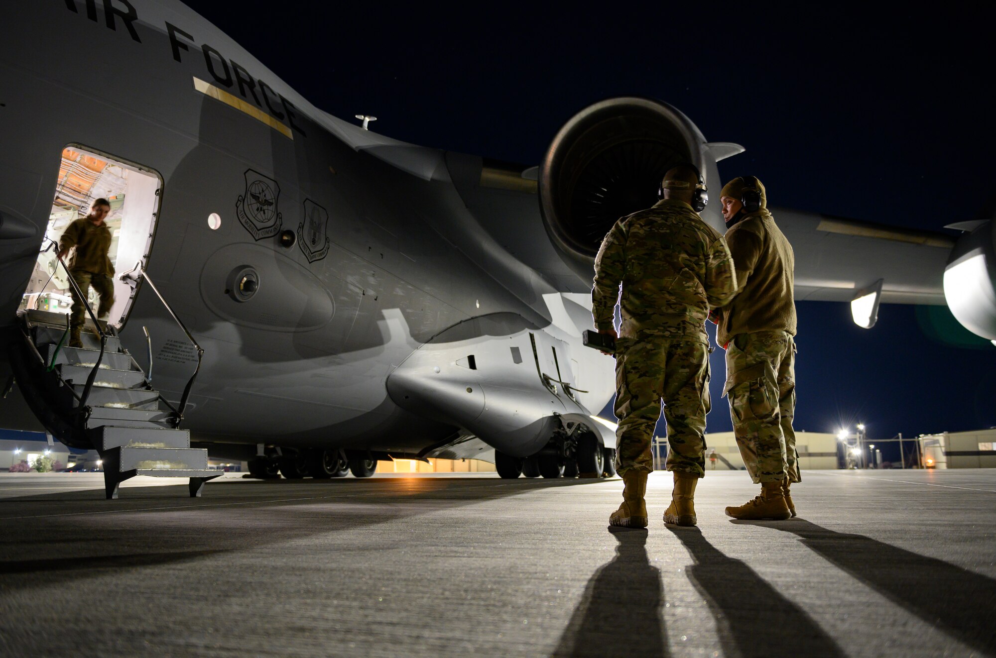 Airmen from the 821st Contingency Response Squadron go through marshalling and parking procedures for a C-17 Globemaster III from Joint Base Lewis-McChord, Washington, at Mountain Home Air Force Base, Idaho, April 27, 2021. The 821st CRS’ ability to rapidly deploy multi-capable Airmen to where they’re needed most was tested throughout exercise Rainier War. The exercise was a multiple-day gauntlet meant to test various units’ capabilities in employing air combat capabilities during a time of potentially imminent foreign aggression. (U.S. Air Force photo by Staff Sgt. Christian Conrad)