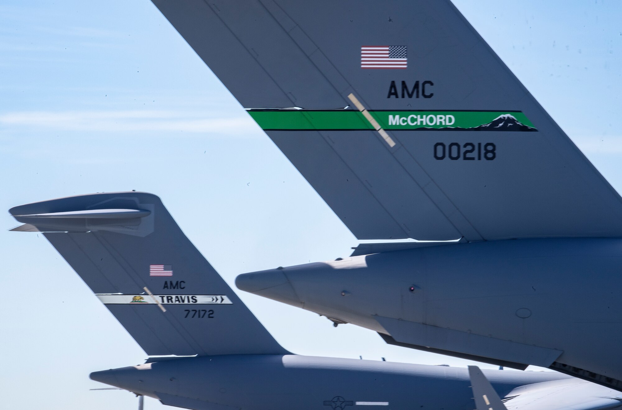 Two C-17 Globemaster IIIs from Joint Base Lewis-McChord, Washington, right, and Travis AFB, California, are parked on the flight line at Mountain Home AFB, Idaho, April 26, 2021. The two C-17s participated in exercise Rainier War, testing their abilities to employ air combat capabilities during a time of potentially imminent foreign aggression. (U.S. Air Force photo by Staff Sgt. Christian Conrad)