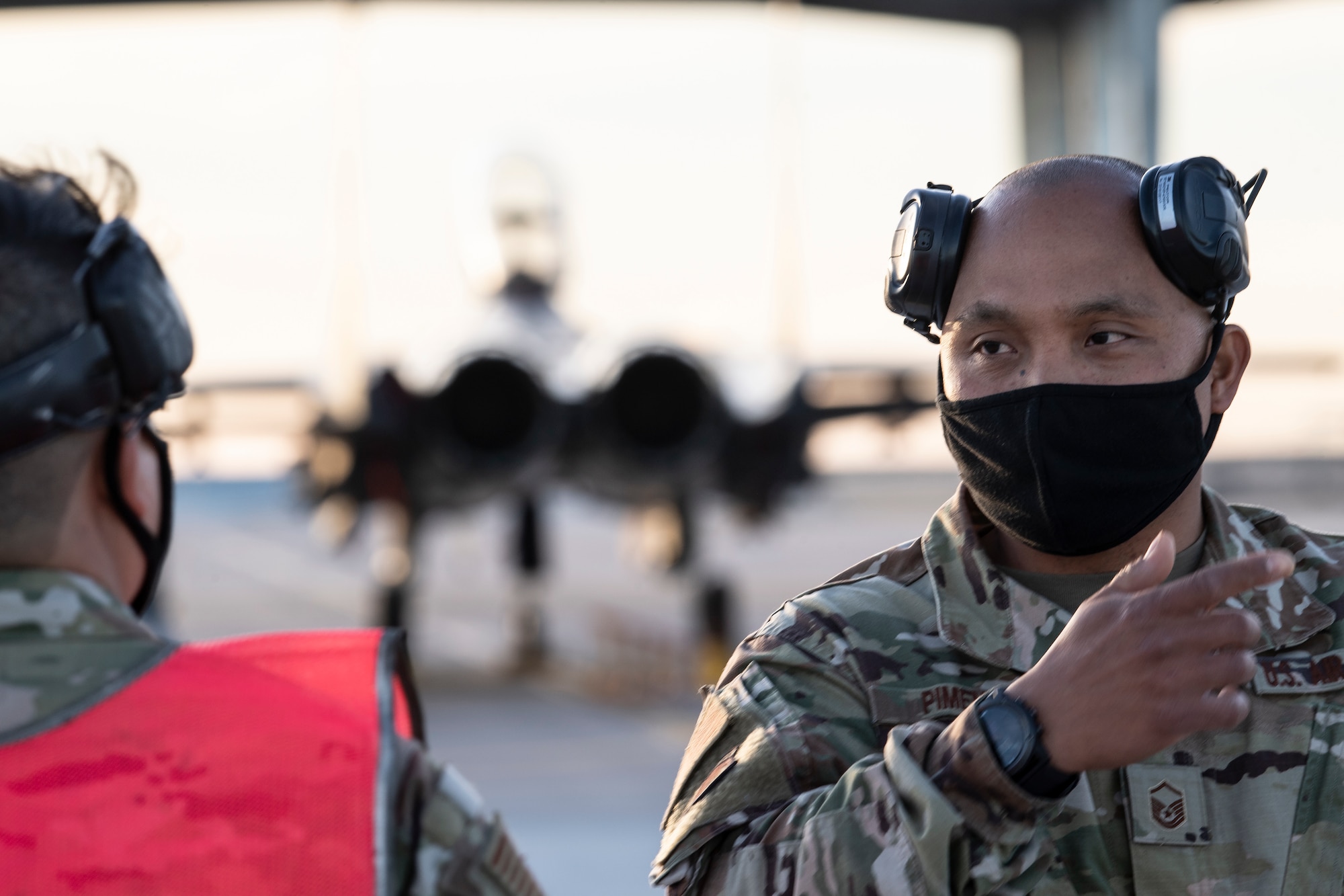 Master Sgt. Dave Pimentel, right, and Tech. Sgt. Joshua Minoda, both 821st Contingency Response Squadron maintenance flights chiefs, discuss marshaling procedures April 27, 2021, at Mountain Home Air Force Base, Idaho. Both Pimentel and Minoda participated in exercise Rainier War, testing their ability to employ air combat capabilities during a time of potentially imminent foreign aggression. (U.S. Air Force photo by Staff Sgt. Christian Conrad)