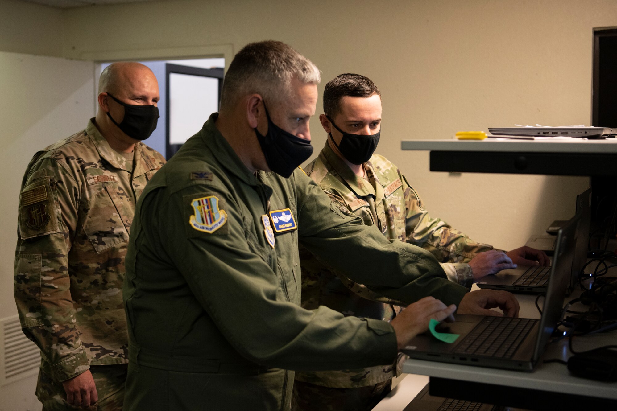 U.S. Air Force Staff Sgt. Cameron Massey, right, 60th Communications Squadron client system supervisor, describes the client system mission to Col. Corey Simmons, 60th Air Mobility Wing commander, center, and Chief Master Sgt. Robert Schultz, 60th AMW command chief, during Leadership Rounds April 30, 2021, at Travis Air Force Base, California. The Leadership Rounds program provides 60th AMW leadership an opportunity to interact with Airmen and receive a detailed view of each mission performed at Travis AFB. (U.S. Air Force photo by Airman 1st Class Alexander Merchak)