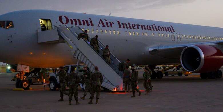 Members of South Carolina Air National Guard’s 169th “Swamp Fox” Fighter Wing leave the aircraft while arriving at Prince Sultan Air Base, Kingdom of Saudi Arabia, April 12, 2021. The Swamp Fox team has been deployed to PSAB to help bolster the defensive capabilities against potential threats in the region. (U.S. Air Force Photo by Senior Airman Samuel Earick)