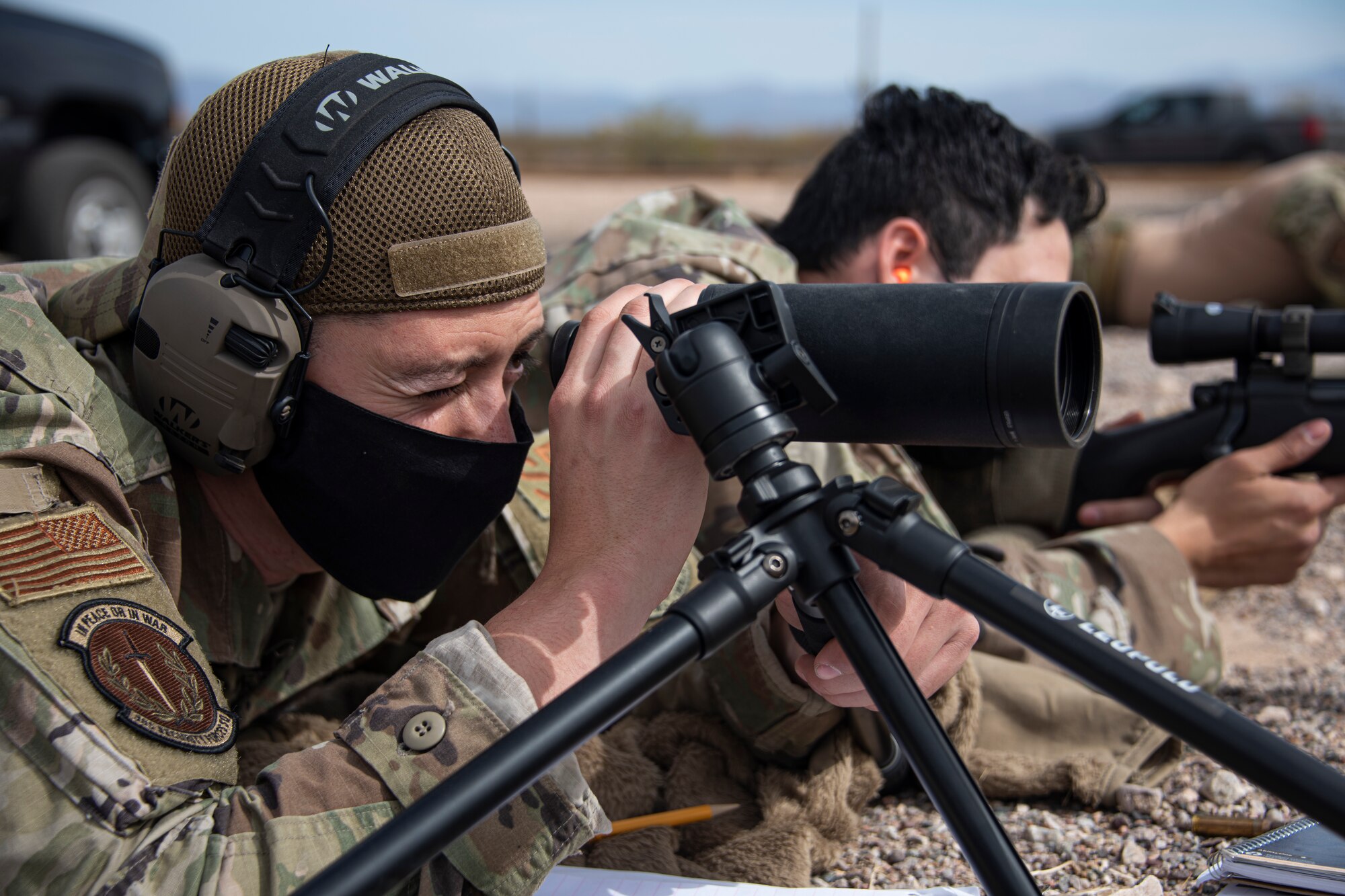 A photo of an Airman aiming a weapon