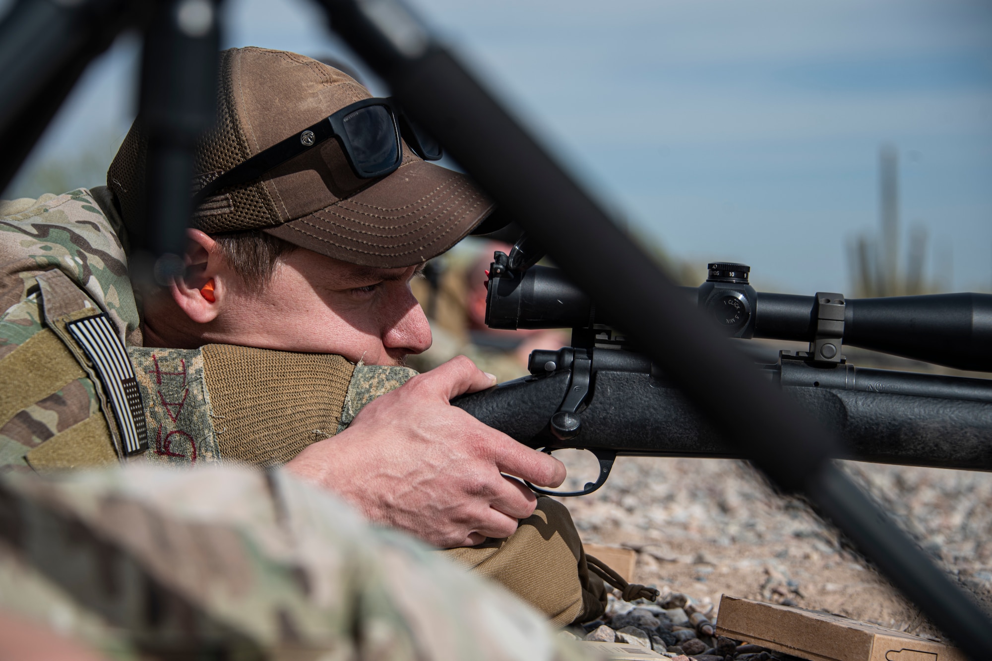 A photo of an Airman aiming a weapon