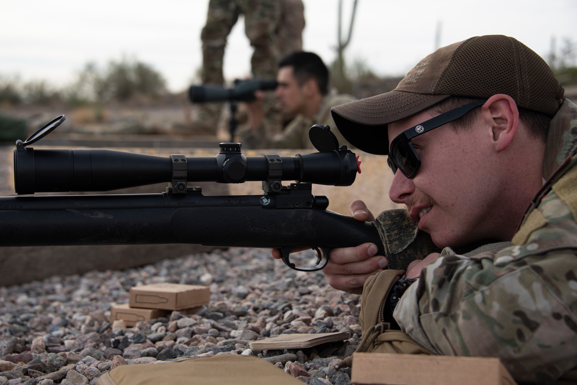 A photo of an Airman aiming a weapon