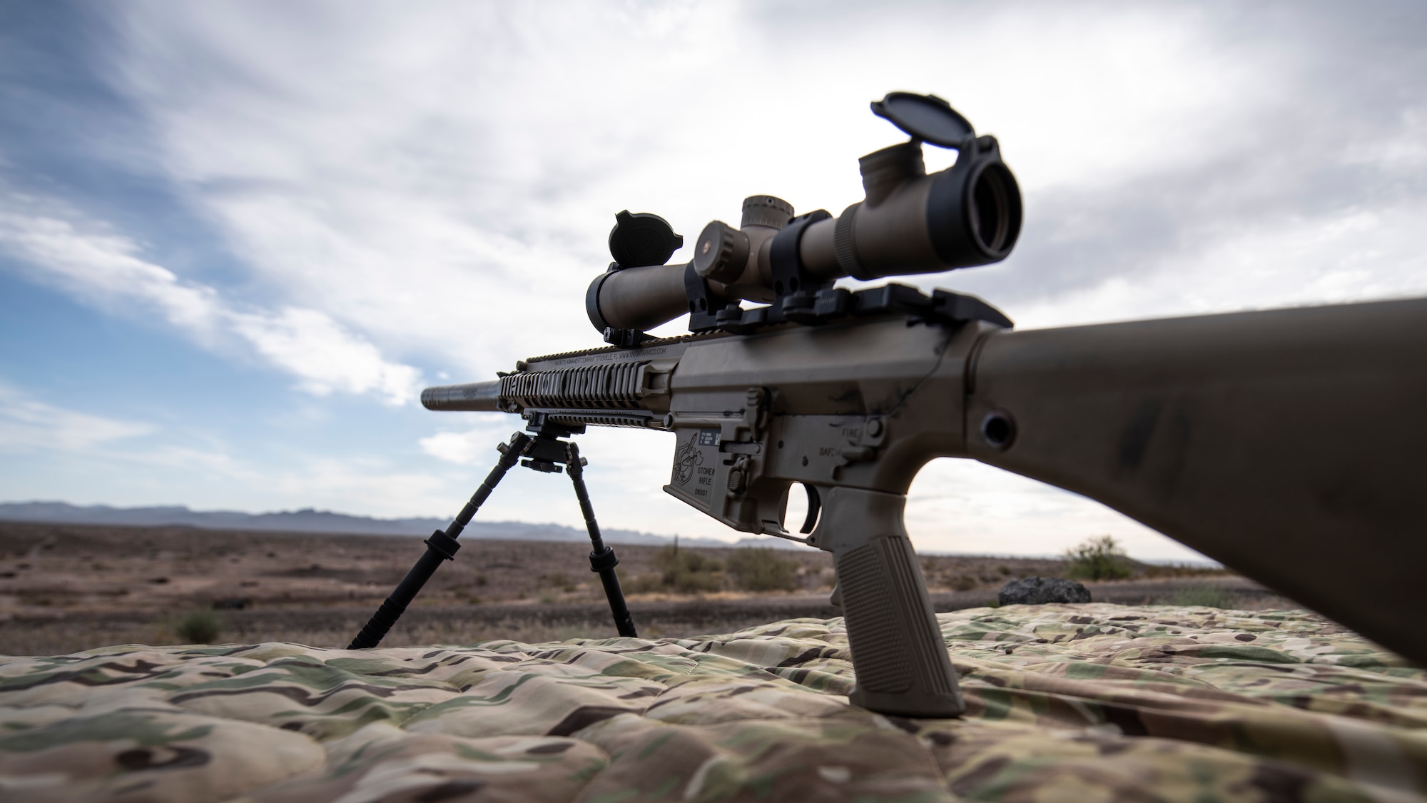 A photo of an Airman aiming a weapon
