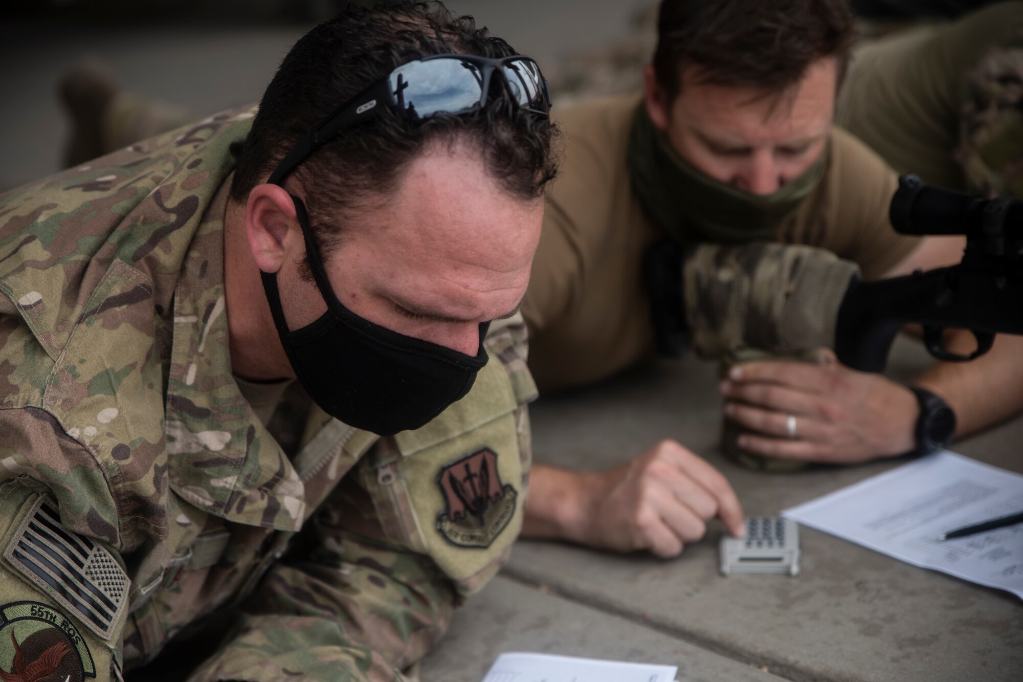 A photo of an Airman aiming a weapon