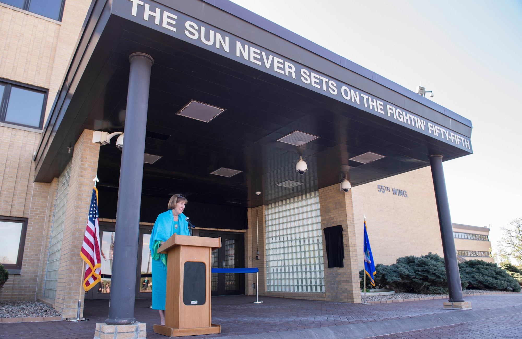 Woman giving a speech while standing at a podium