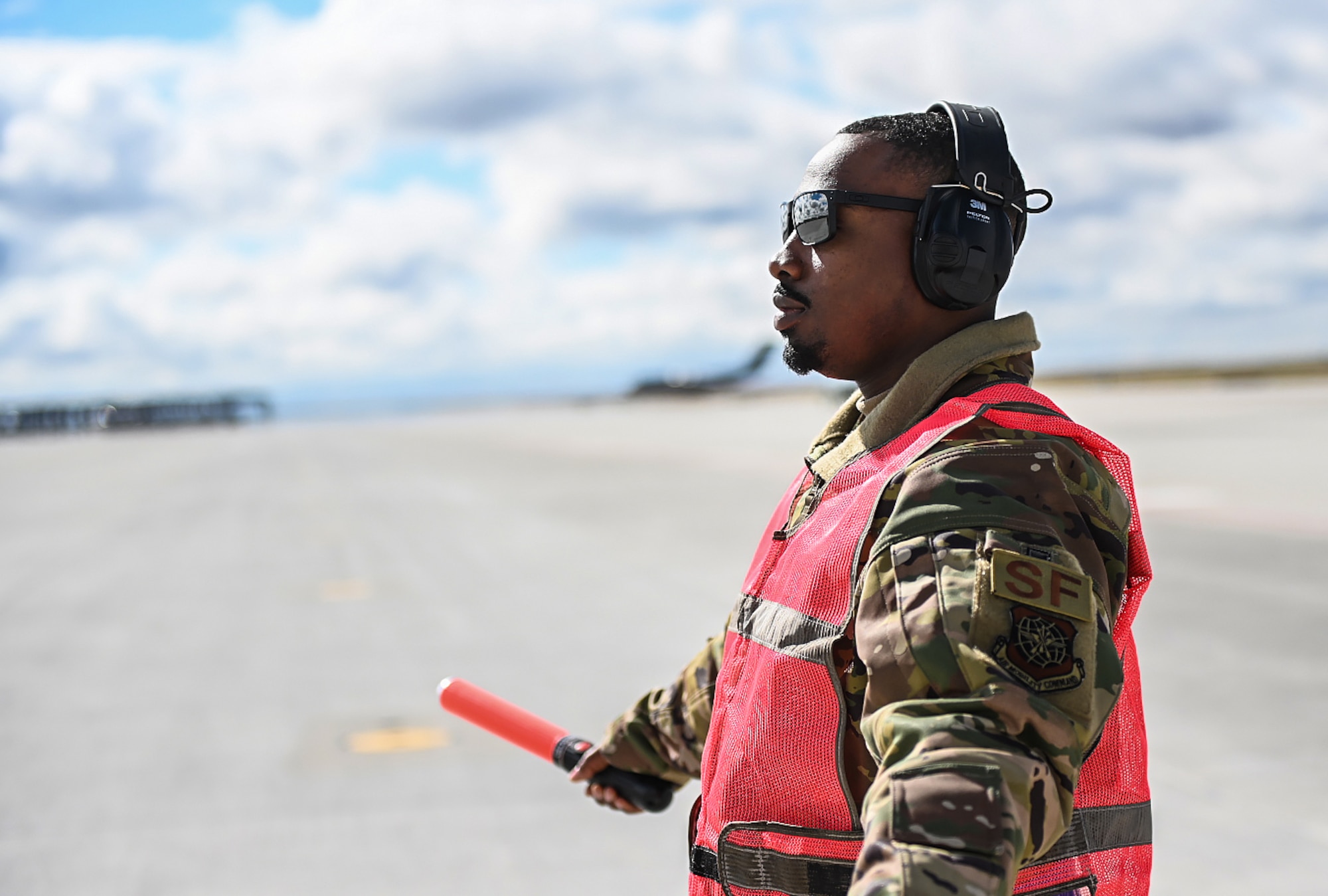 Senior Airman Antoine Barnes, 821st Contingency Response Squadron fire team member, marshals a C-17 Globemaster III from Joint Base Lewis-McChord, Washington, April 27, 2021, on the flight line at Mountain Home AFB, Idaho. Barnes participated in exercise Rainier War, testing his abilities to employ air combat capabilities during a time of potentially imminent foreign aggression. (U.S. Air Force photo by Staff Sgt. Christian Conrad)