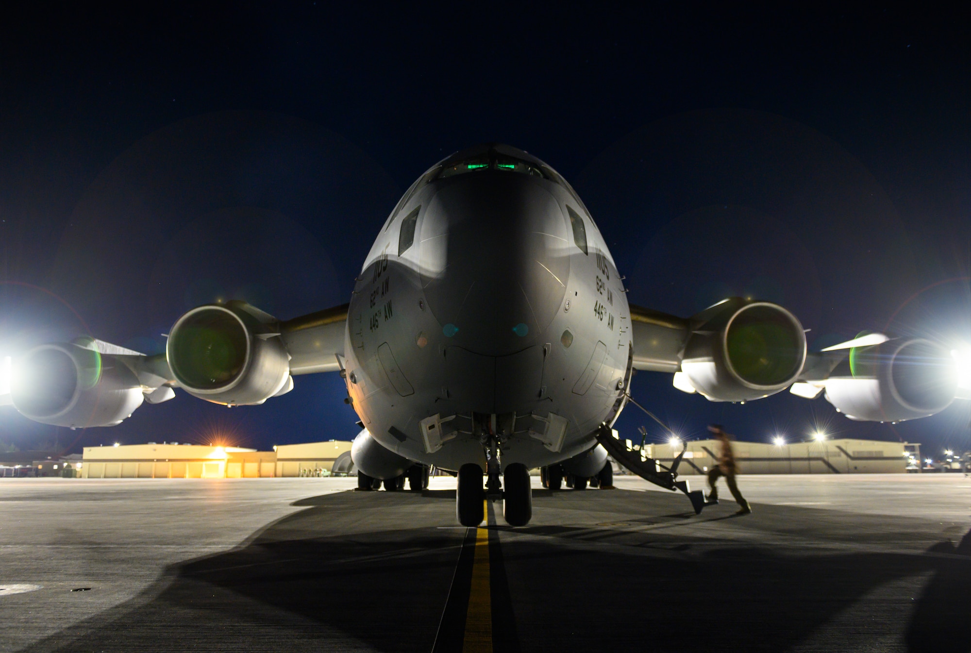 An Airman boards a C-17 Globemaster III from Joint Base Lewis-McChord, Washington, on the flight line at Mountain Home Air Force Base, Idaho, April 27, 2021. The C-17 played a prominent role in exercise Rainier War by ensuring prompt distribution of both defensive and offensive capabilities to simulated areas during the training. (U.S. Air Force photo by Staff Sgt. Christian Conrad)