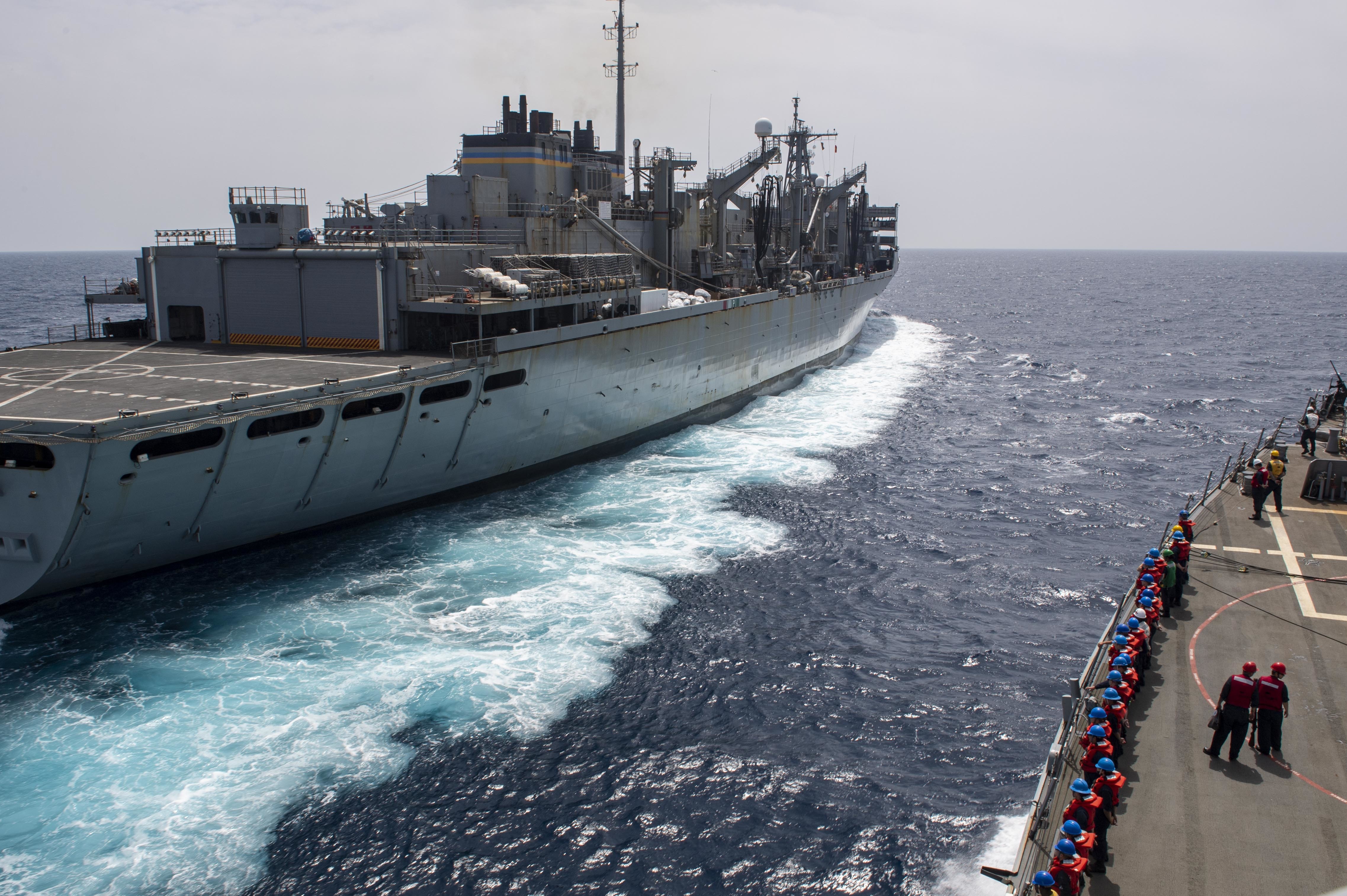 Sailors attached to the guided-missile destroyer USS Laboon (DDG 58) man the rails as Laboon approaches the Military Sealift Command fast combat support ship USNS Arctic (T-AOE-8) for a replenishment-at-sea in the Arabian Sea.