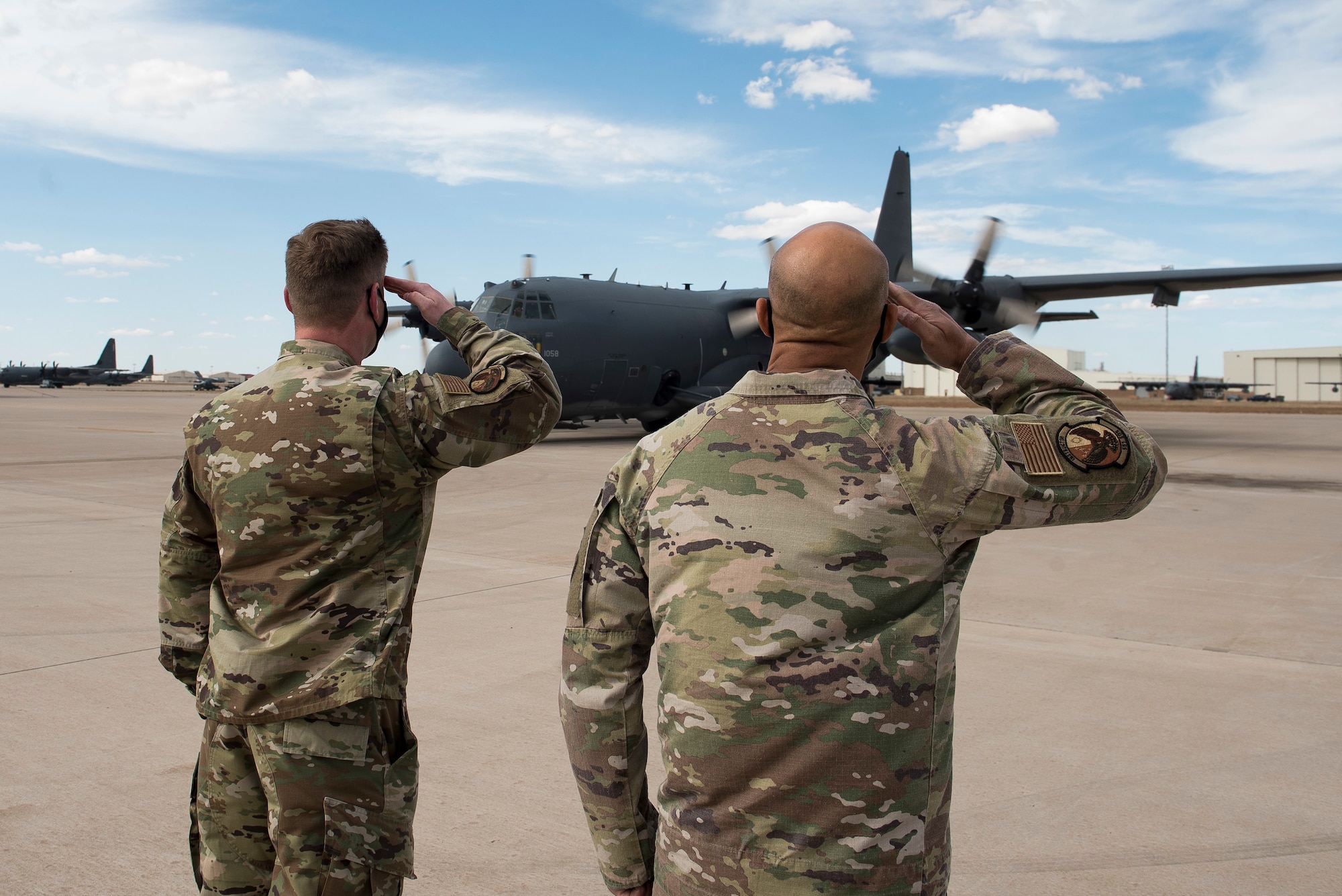 Lt. Col. Kris Airkens, 551st Special Operations Squadron commander, and Senior Master Sgt. Aaron Drain, 551 SOS senior enlisted leader, salute an AC-130W aircraft as it pulls in after a flight at Cannon Air Force Base, N.M., April 29, 2021. The squadron, a tenant unit of the 492nd Special Operations Wing, has been at Cannon since July 24, 2009, after its reactivation. (U.S. Air Force photo by Senior Airman Vernon R. Walter III)