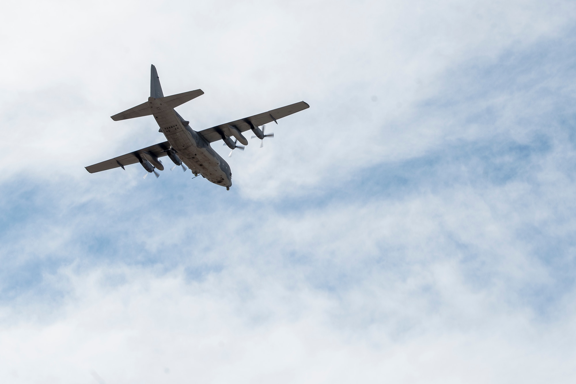 An AC-130W aircraft, piloted by members of the 551st Special Operations Squadron, flies over Cannon Air Force Base, N.M., April 29, 2021. The flight was flown to commemorate the last training flight of the 551 SOS. (U.S. Air Force photo by Senior Airman Vernon R. Walter III)