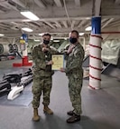 U.S. Air Force Senior Airman Alexander Garrett received an Armed Forces Service Medal from the ship’s information officer for his work aboard the U.S.S. Blue Ridge (LCC-19). The 3rd Operations Support Squadron intelligence analyst was the only Airman on board.