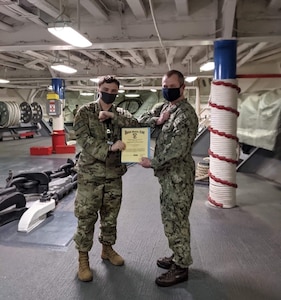 U.S. Air Force Senior Airman Alexander Garrett received an Armed Forces Service Medal from the ship’s information officer for his work aboard the U.S.S. Blue Ridge (LCC-19). The 3rd Operations Support Squadron intelligence analyst was the only Airman on board.