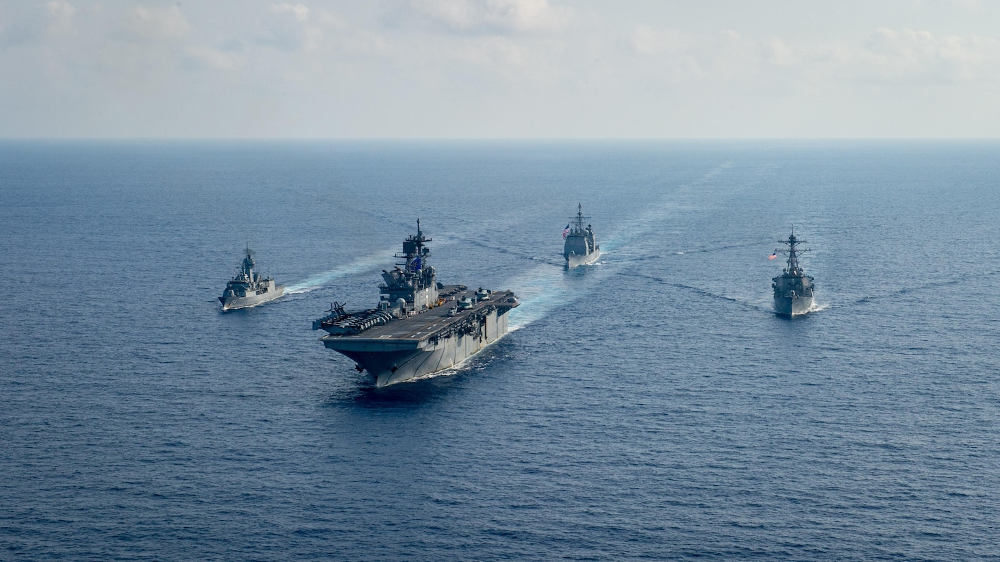 Royal Australian Navy guided-missile frigate HMAS Parramatta (FFH 154), left, sails with U.S. Navy Amphibious assault ship USS America (LHA 6), Ticonderoga-class guided-missile cruiser USS Bunker Hill (CG 52) and Arleigh-Burke class guided missile destroyer USS Barry (DDG 52). Bunker Hill is deployed to the U.S. 7th Fleet area of operations and is operating with the America Expeditionary Strike Group in support of security and stability in the Indo-Pacific region. (U.S. Navy photo by Petty Officer 3rd Class Nicholas Huynh)