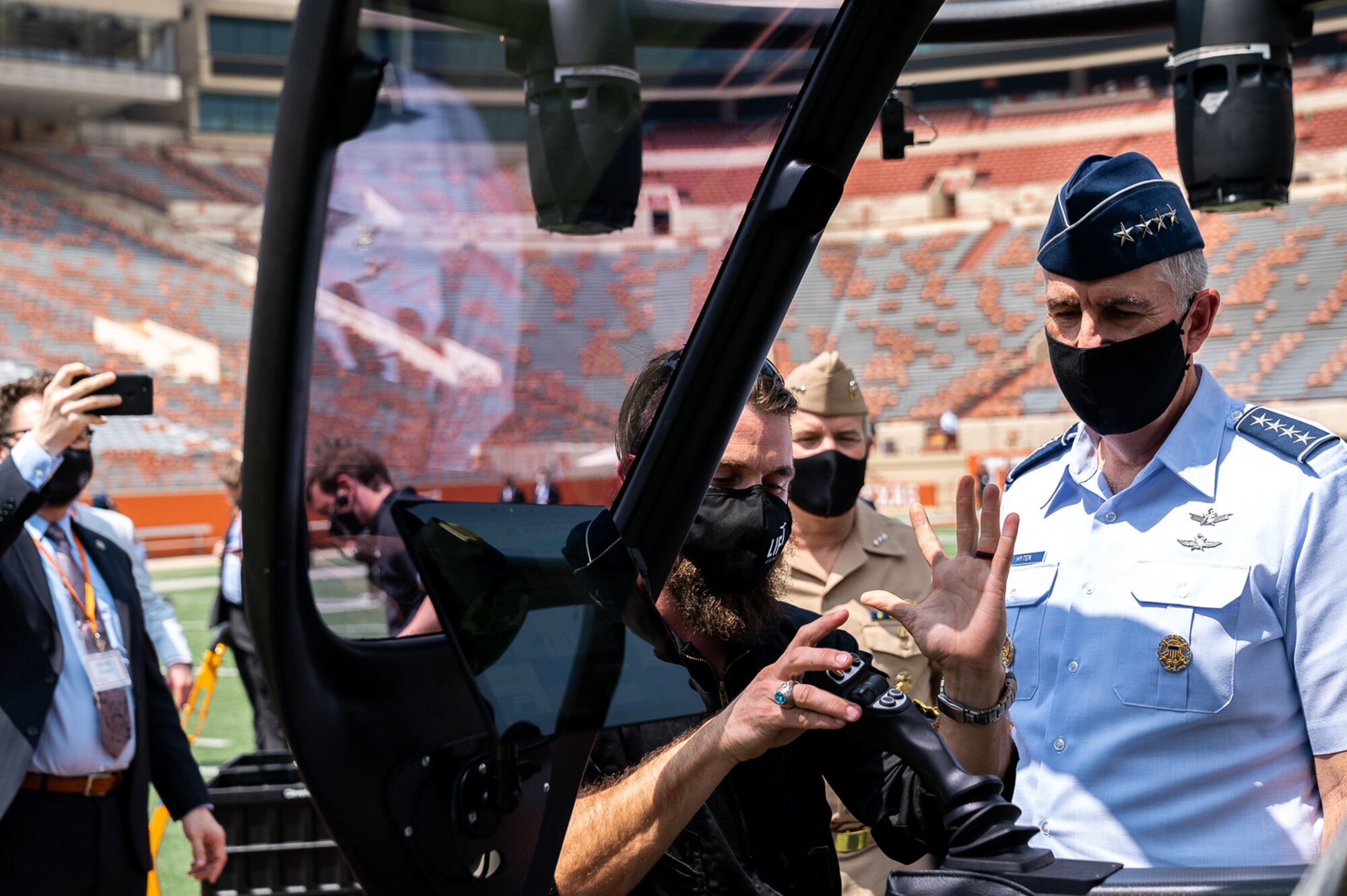After a landing in the University of Texas at Austin football stadium, LIFT Aircraft’s Flight Development Engineer and Chief Pilot, Jace McCown, explains to Vice Chairman of the Joint Chiefs of Staff, Gen. John E. Hyten, how to operate LIFT’s “Hexa” electric vertical takeoff and landing aircraft. (Photo courtesy of Joint Requirements Oversight Council)