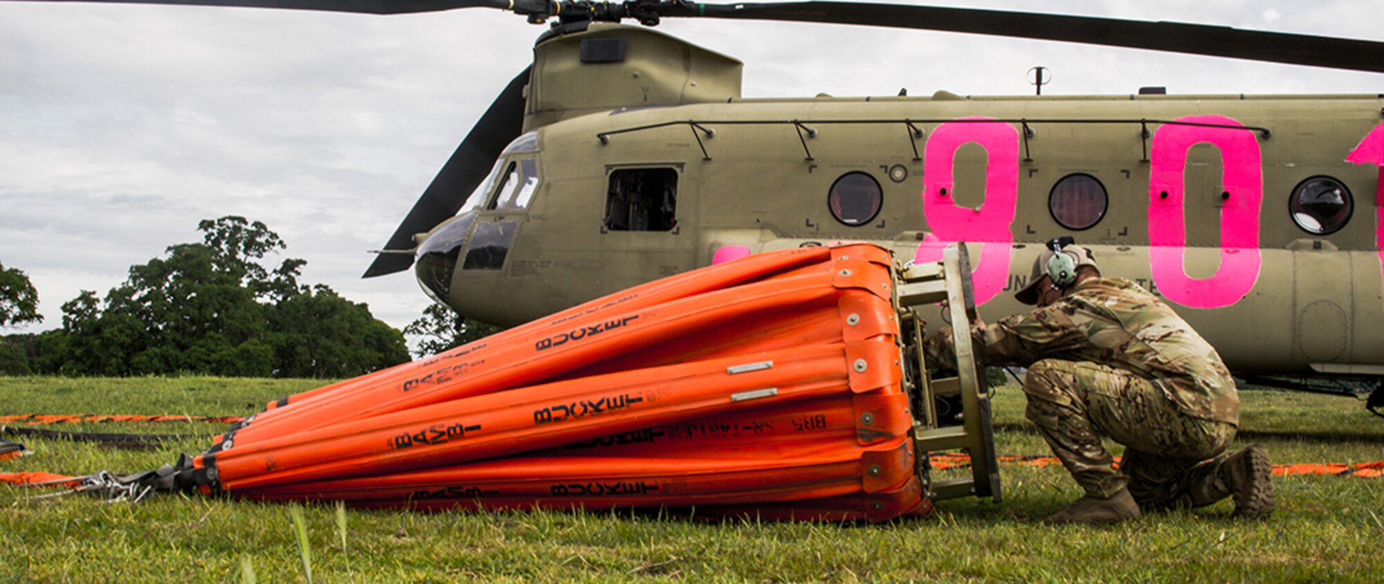 A U.S. Army Soldier from the 3-140th Aviation Regiment, California National Guard, performs a final check on the water bucket of a U.S. Army CH-47 Chinook helicopter before participating in annual joint aerial fire fighting training near Ione, California, April 24, 2021.