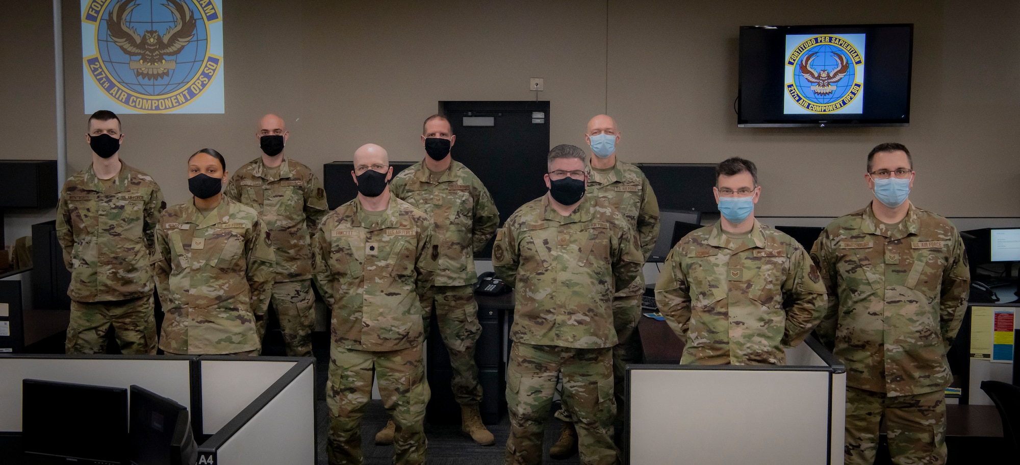 Members of the 110th Wing (pictured from left to right), Senior Airman Donovan Wentworth, 110th Communications Flight; Staff Sgt. Jennifer Rumsey, Tech. Sgt. Justin Oosterbaan, Lt. Col. Daniel Fawcett, Tech. Sgt. Robert Zellers, Master Sgt. Brian Leonard, Tech. Sgt. Lewis Banks, Staff Sgt. Robert Rainone, 217th Air Component Operations Squadron and Staff Sgt. Ryan Swartzendruber, the 110th Operations Group, stands for a team photo on April 29, 2021, at Battle Creek Air National Guard Base, Battle Creek, Mich.