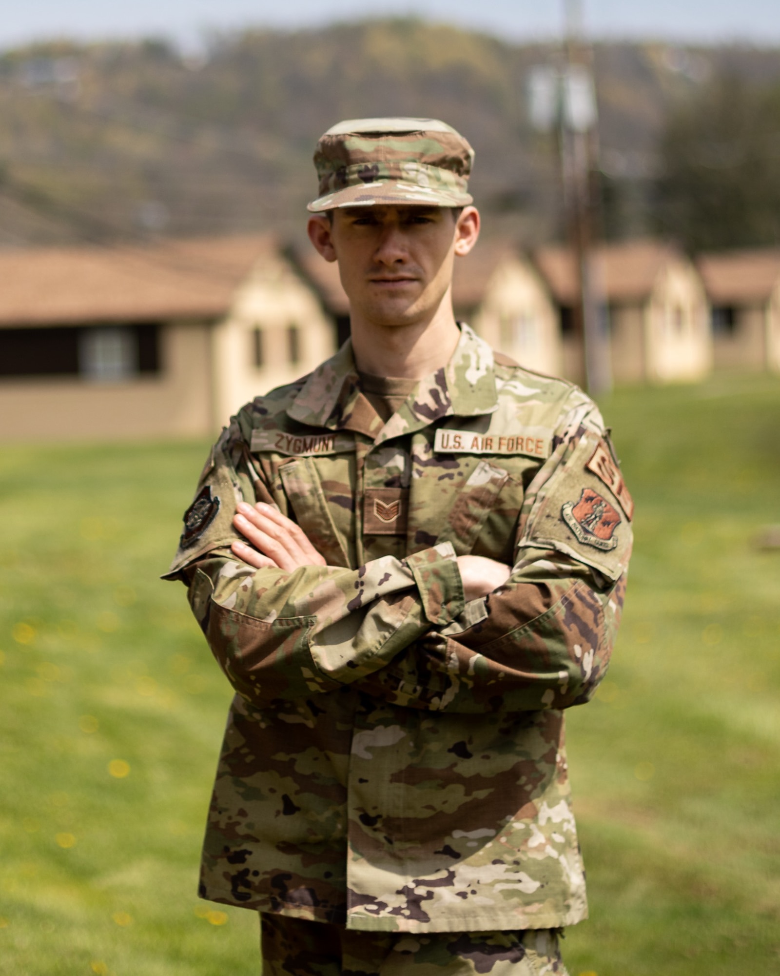 U.S. Air Force Staff Sgt. Anthony Zygmunt, a security forces specialist for the 167th Airlift Wing, poses for a photo at the start of the 2021 West Virginia Best Warrior competition at Camp Dawson in Kingwood, West Virginia, Apr. 23, 2021. Physical capabilities, leadership skills, teamwork and critical thinking are just some of abilities possessed by Airmen and Soldiers participating in the competition.