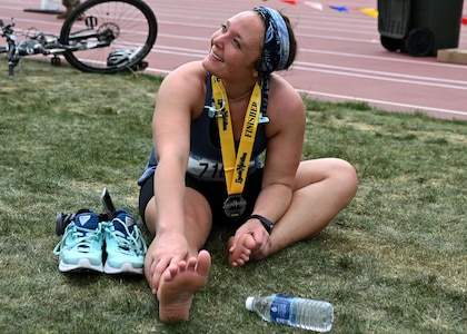Cpl Kayla Denison of A Battery, 3rd Battalion, 197th Field Artillery Brigade, stretches out at University of Nebraska's Ed Weir Stadium following her May 2 Lincoln Marathon finish in Lincoln, Neb.