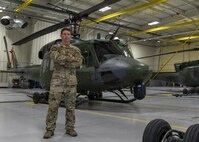 Captain Kevin Cornell, a Helicopter Pilot Instructor for the 54th Helicopter Squadron, poses infront of helicopters and interacts with teammates on May 4, 2021 at Minot Air Force Base, North Dakota. (U.S. Air Force photo by SrA Michael Richmond)