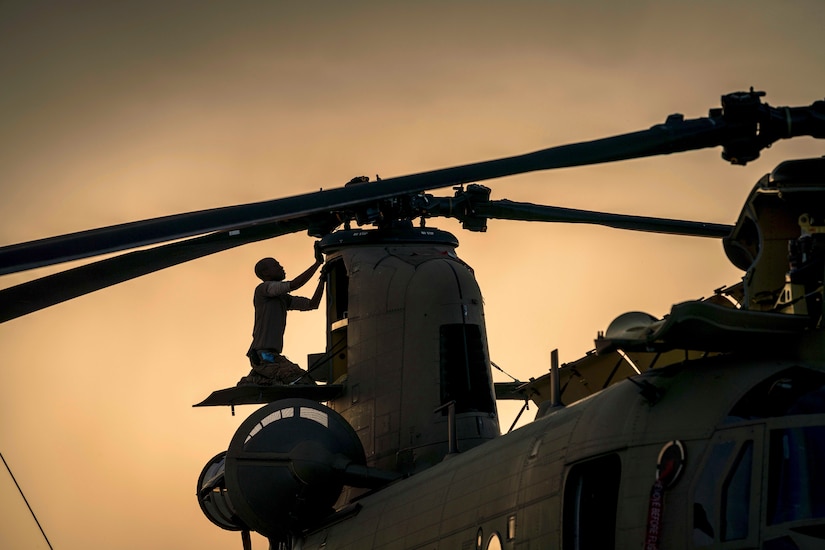 A soldier works on an aircraft.